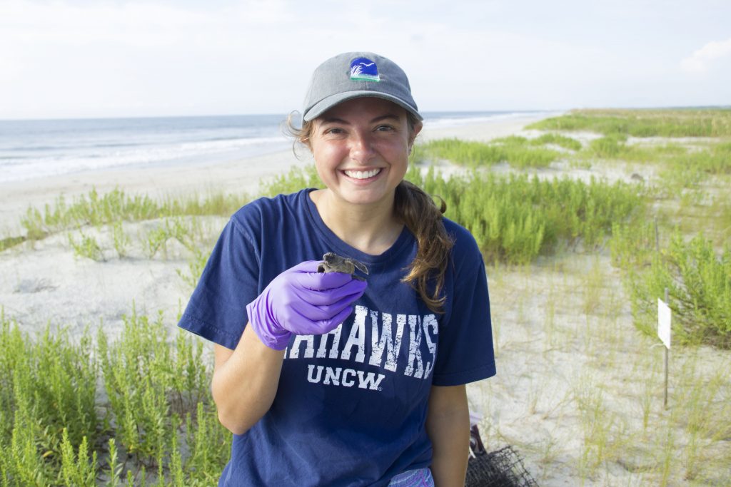 Calle Boatright on Masonboro Island with baby sea turtle